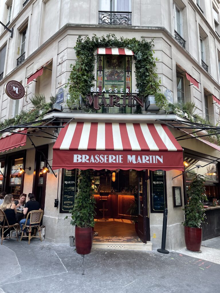 Brasserie Martin with red-and-white awning in a lively Parisian neighborhood